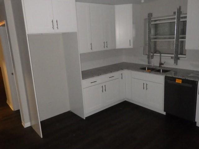 kitchen featuring white cabinetry, dishwasher, light stone counters, and sink