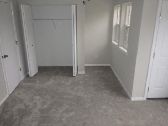 unfurnished bedroom featuring dark colored carpet