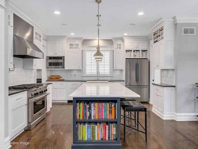 kitchen with pendant lighting, sink, white cabinetry, and stainless steel appliances