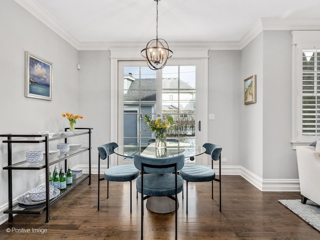 dining space with dark hardwood / wood-style flooring, crown molding, and a chandelier