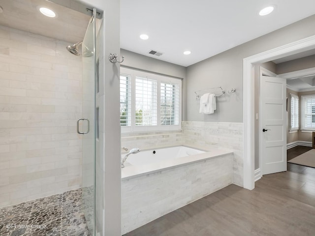 bathroom featuring hardwood / wood-style floors and shower with separate bathtub