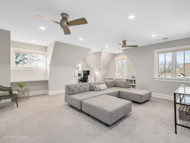 living room featuring ceiling fan, lofted ceiling, and light carpet