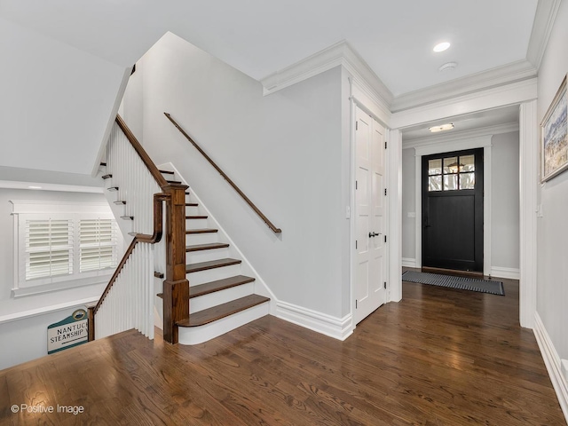 entrance foyer featuring crown molding and dark hardwood / wood-style flooring