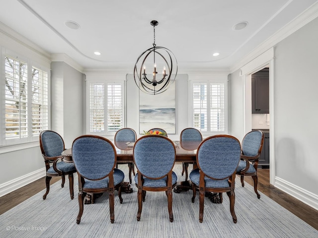 dining area with crown molding, plenty of natural light, and light hardwood / wood-style floors