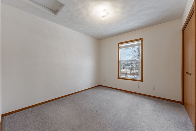 empty room with light carpet and baseboards