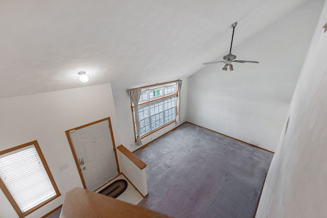 carpeted foyer entrance with vaulted ceiling and ceiling fan