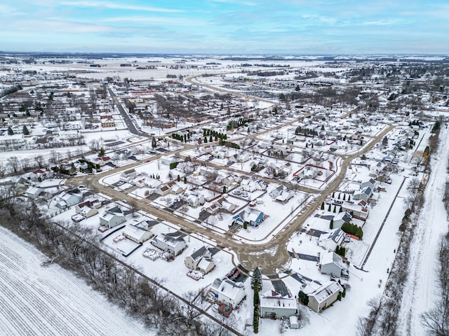 snowy aerial view with a residential view