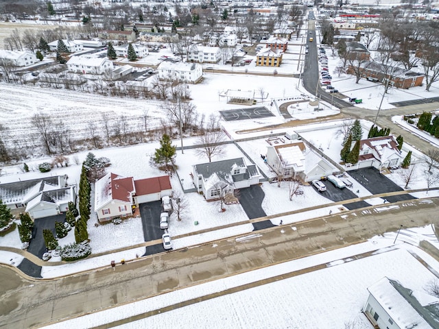 snowy aerial view with a residential view