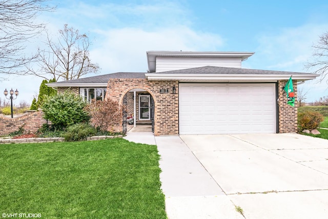 view of front of house with a garage and a front lawn