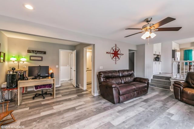 living room with hardwood / wood-style floors and ceiling fan