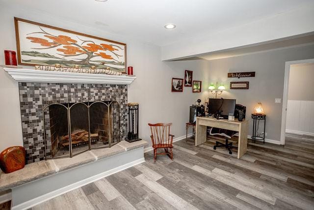 interior space with a fireplace and hardwood / wood-style flooring