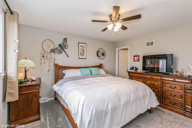 bedroom with ceiling fan and dark carpet