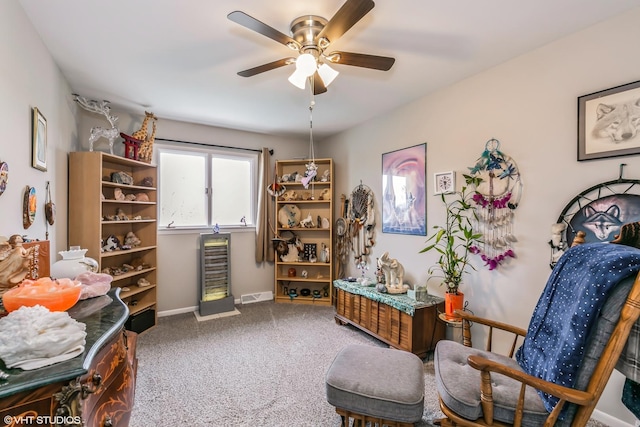 sitting room featuring carpet and ceiling fan