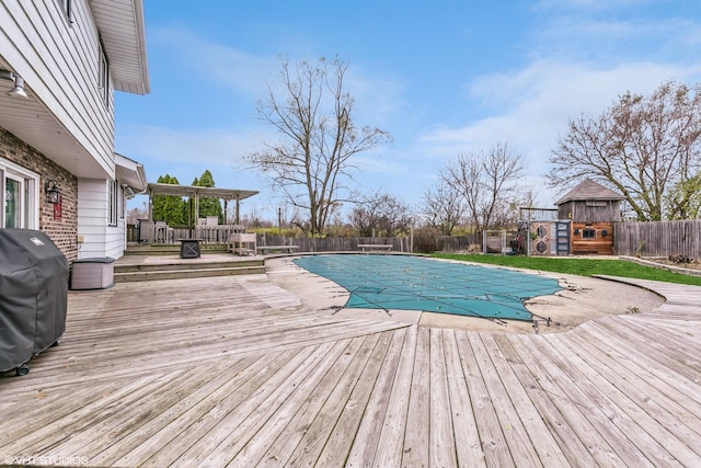 view of swimming pool with a deck and grilling area