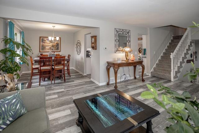 living room featuring an inviting chandelier and hardwood / wood-style flooring