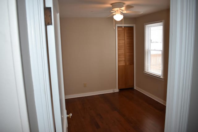 spare room with ceiling fan and dark hardwood / wood-style floors