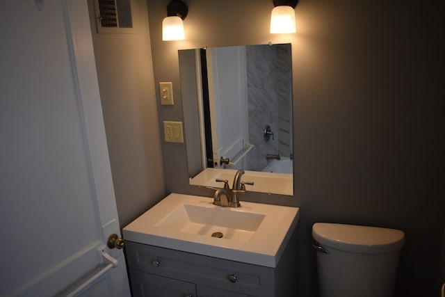 bathroom featuring vanity and toilet