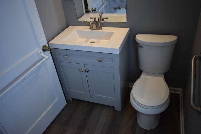 bathroom with hardwood / wood-style floors, vanity, and toilet