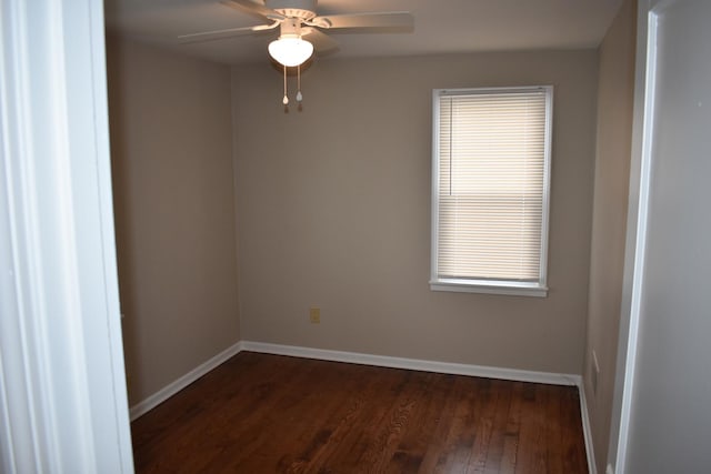 spare room featuring ceiling fan and dark wood-type flooring