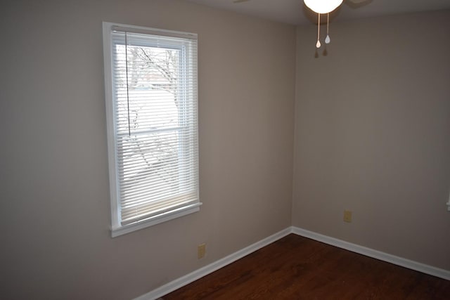 empty room featuring ceiling fan and dark hardwood / wood-style flooring