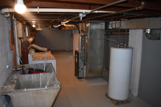 basement featuring washer / dryer, sink, heating unit, and water heater