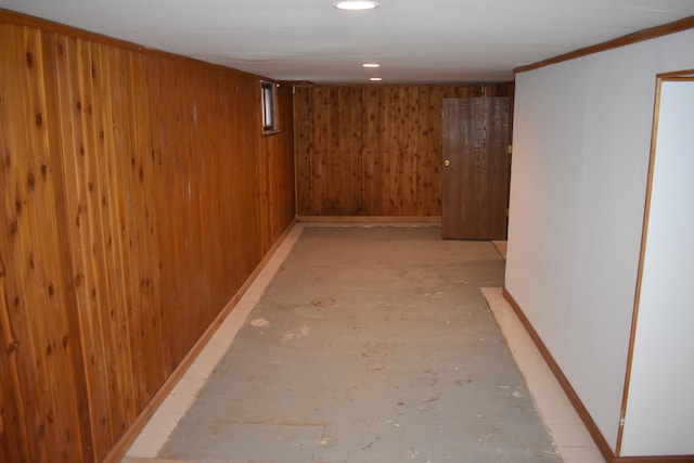 basement featuring wooden walls