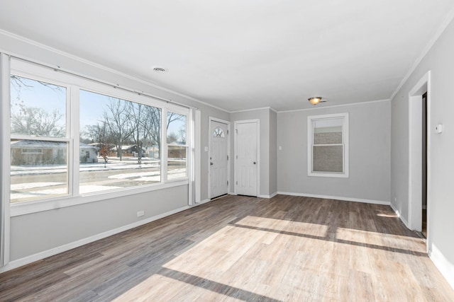 unfurnished room featuring hardwood / wood-style flooring and ornamental molding