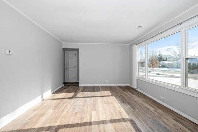 unfurnished room featuring wood-type flooring and crown molding