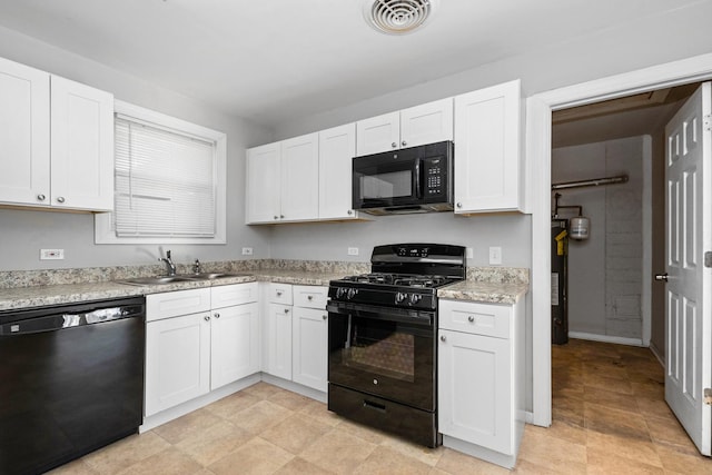 kitchen with black appliances, light stone countertops, white cabinetry, and sink