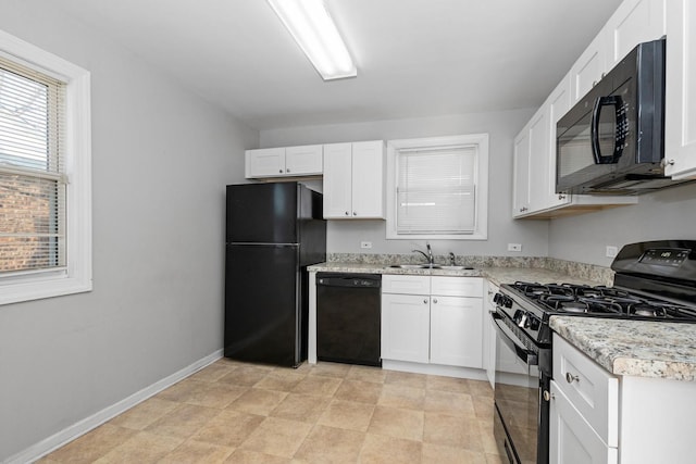 kitchen with white cabinetry, sink, and black appliances