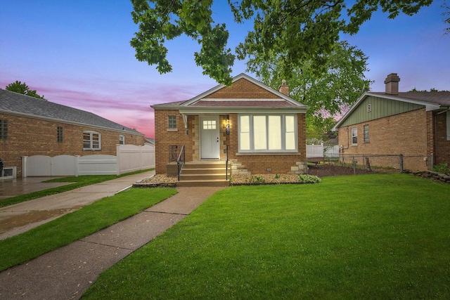 view of front of house with a yard