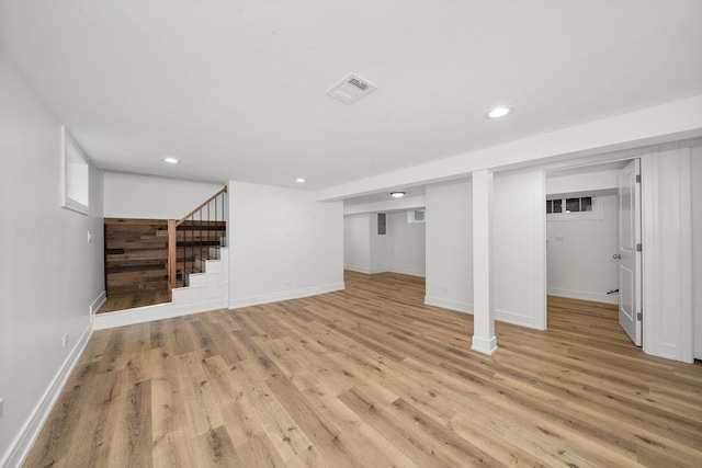 basement with light hardwood / wood-style floors