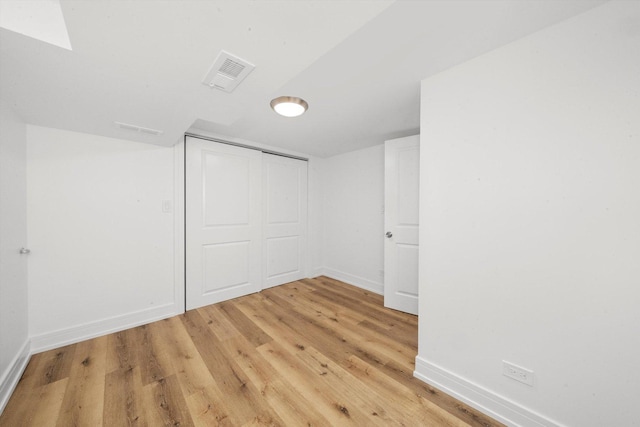 interior space with hardwood / wood-style flooring and a closet