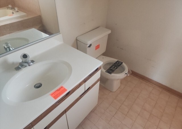 bathroom with tile patterned floors, vanity, and toilet