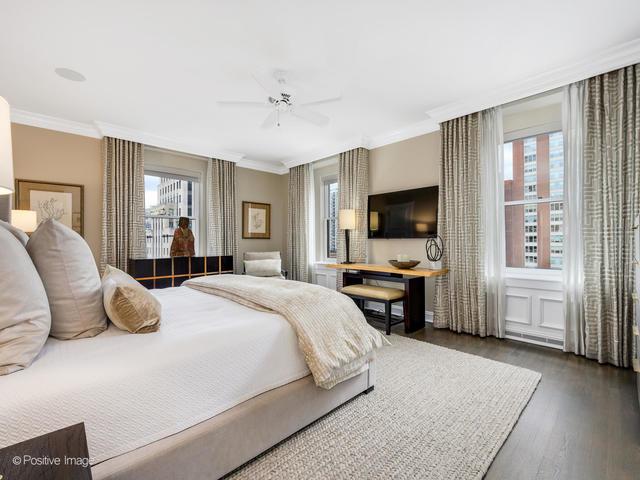 bedroom featuring dark hardwood / wood-style floors, ceiling fan, and crown molding