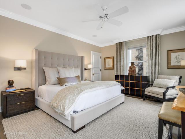 bedroom with ceiling fan, crown molding, and wood-type flooring