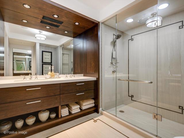 bathroom featuring tile patterned flooring, vanity, and walk in shower