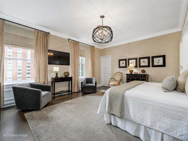 bedroom with a notable chandelier, dark hardwood / wood-style flooring, and ornamental molding