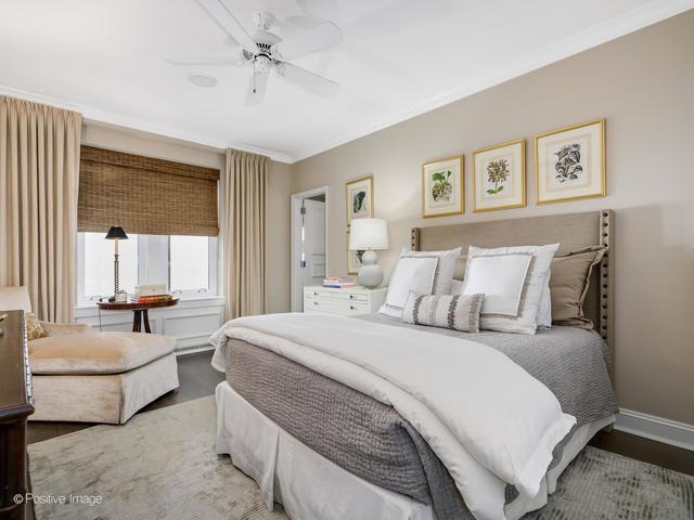 bedroom featuring radiator heating unit, hardwood / wood-style flooring, ceiling fan, and ornamental molding