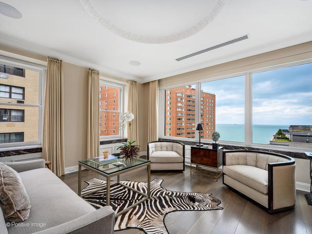 interior space featuring plenty of natural light, a water view, dark wood-type flooring, and ornamental molding