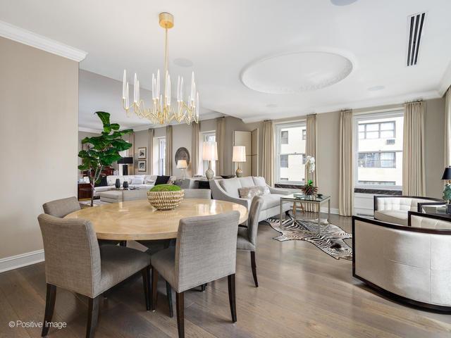 dining room with crown molding, dark wood-type flooring, and a notable chandelier