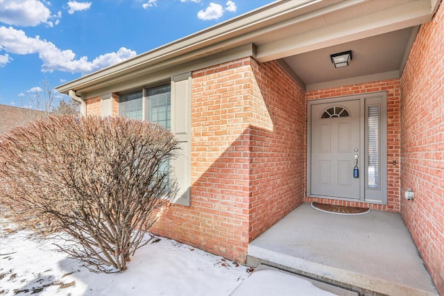 view of snow covered property entrance