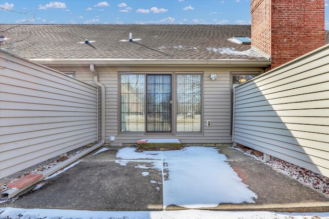 view of exterior entry featuring a patio area