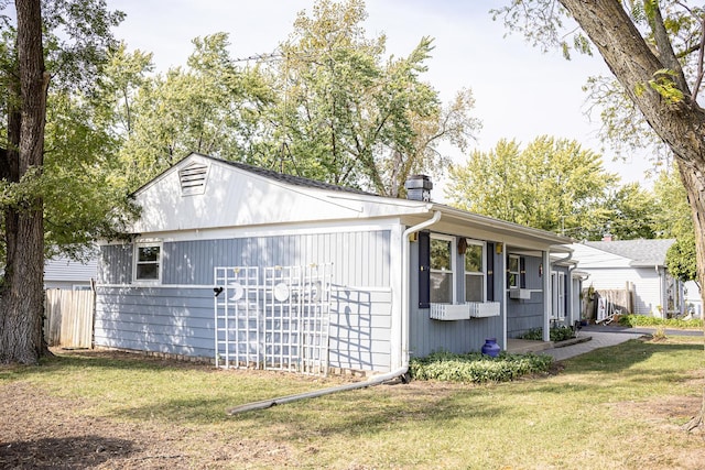 view of side of property with a yard