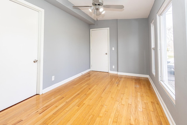 empty room with light hardwood / wood-style flooring and ceiling fan