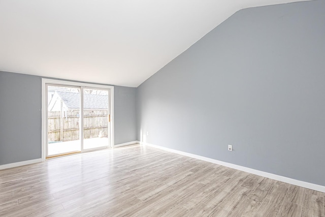 empty room featuring light hardwood / wood-style floors and lofted ceiling