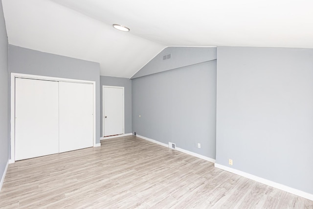 bonus room featuring light hardwood / wood-style floors and vaulted ceiling