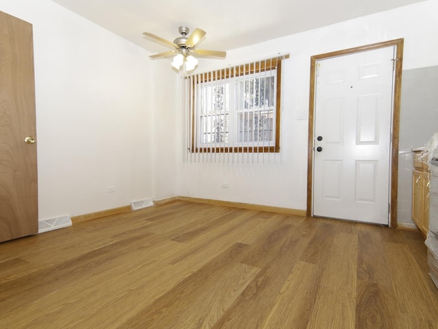 7251 S Ridgeland Ave Unit E, Chicago, IL 60649 - foyer entrance featuring light wood-type flooring and ceiling fan