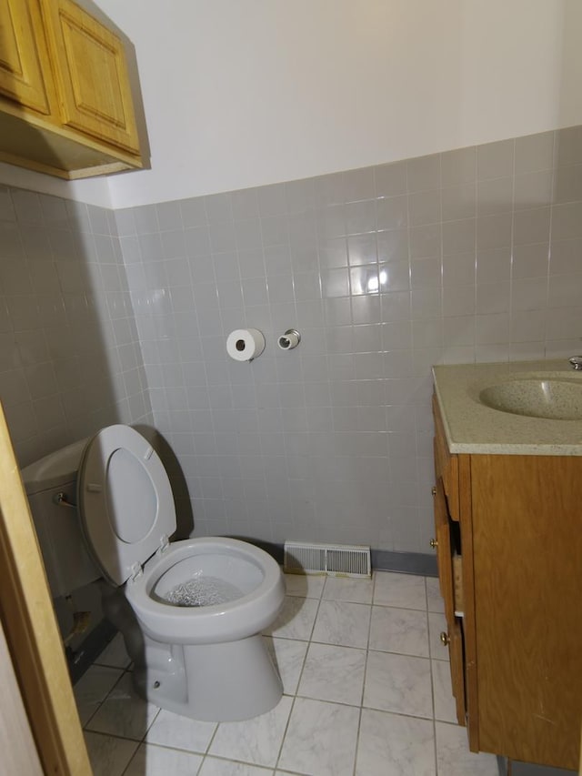 7251 S Ridgeland Ave Unit E, Chicago, IL 60649 - half bathroom featuring tile walls and vanity