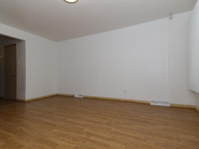 7251 S Ridgeland Ave Unit E, Chicago, IL 60649 - empty room featuring light wood-style floors and baseboards
